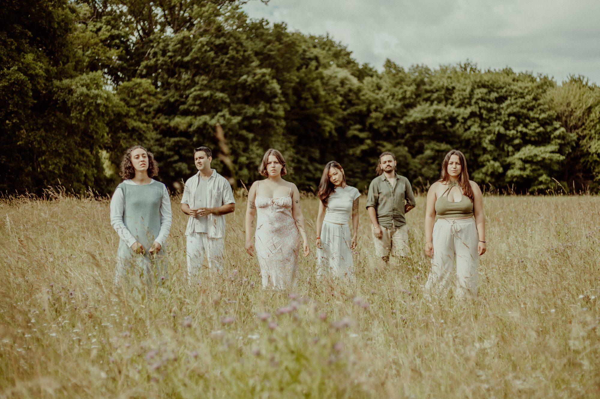 The six members of Once We Knew standing together in a field
